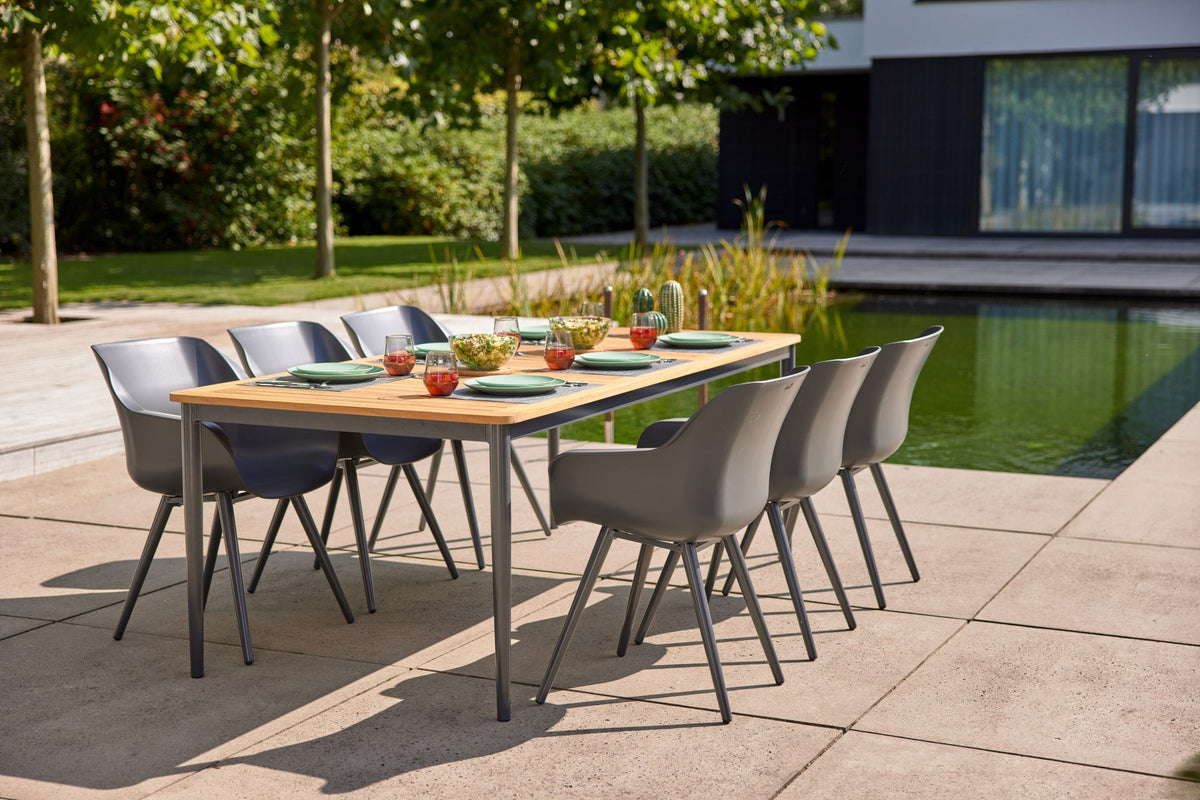 houten tuintafel van teak naast een keramiek tafelblad